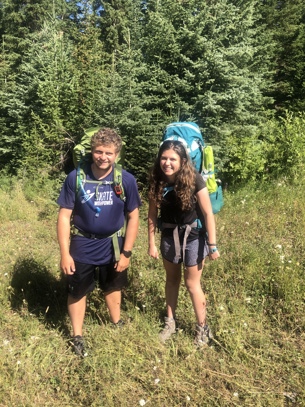 two people against a wilderness background